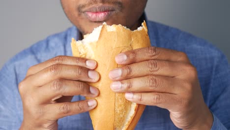 person eating a baguette