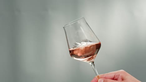 orange or white wine bottle and glass against a sunset in a peaceful vineyard, pouring of ecological natural wine.