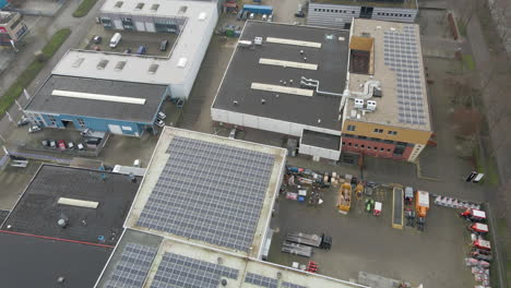 aerial of industrial rooftops filled with solar panels