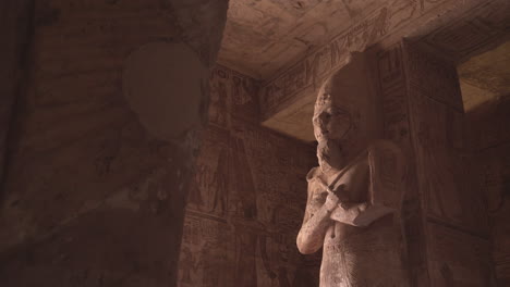 shot of a big statue of osiris in the interior of abu simbel