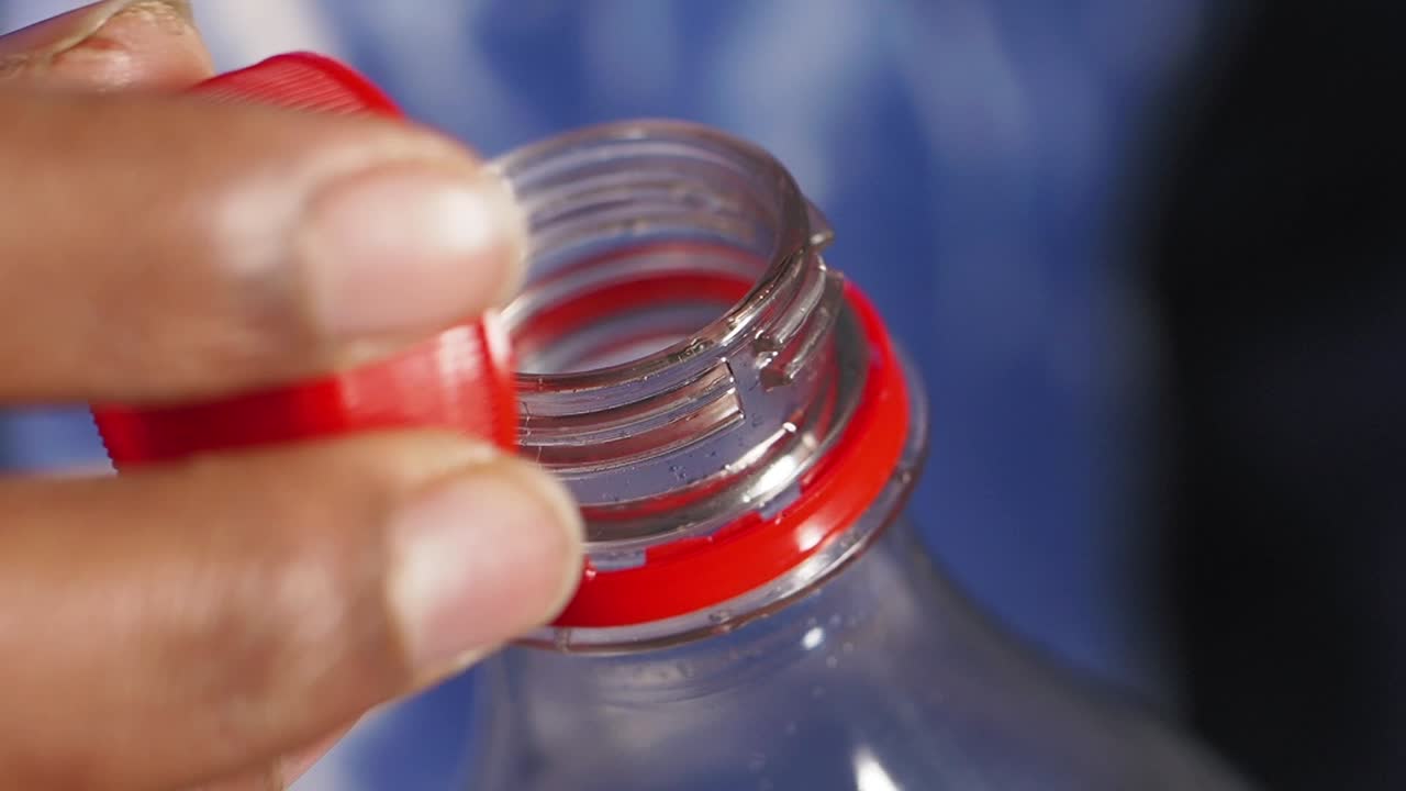 Person Opening a Plastic Bottle Cap