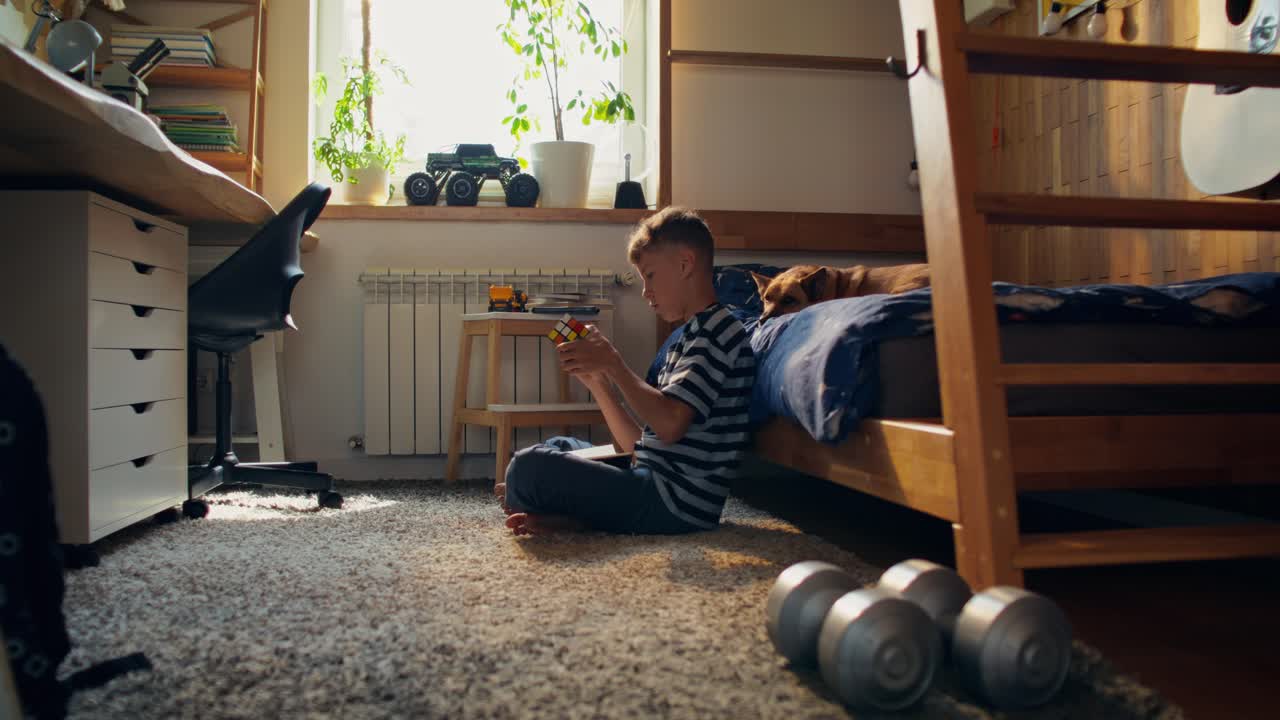 Boy playing with a puzzle in his bedroom