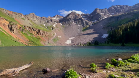 Cinematic-aerial-drone-alpine-sunset-at-Blue-Lakes-Colorado-Mount-Sniffels-Dallas-Peaks-Wilderness-snow-14er-peak-purple-wildflowers-Ridgway-Telluride-Ouray-Silverton-hike-slow-pan-to-left-motion