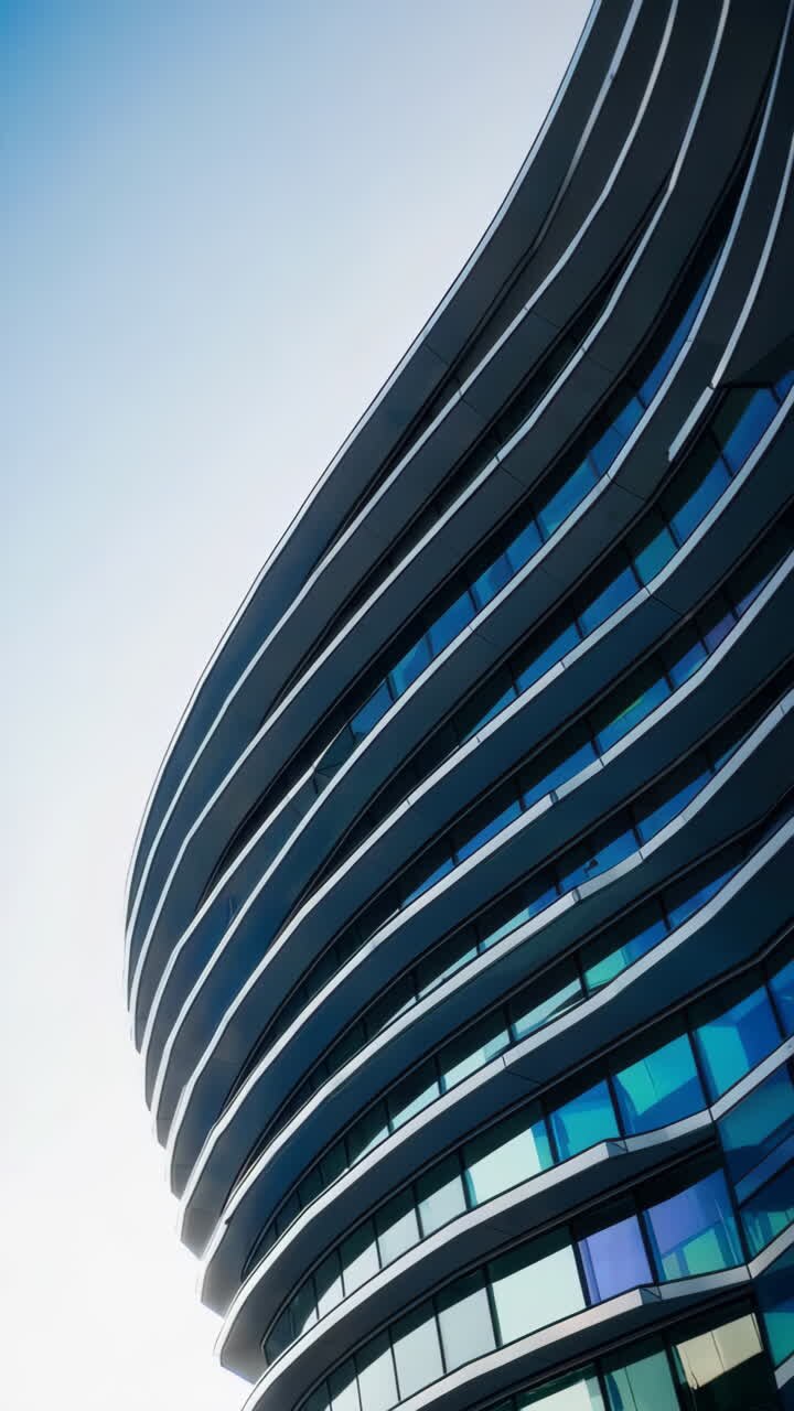 Facciata moderna e curva di un edificio con finestre riflettenti