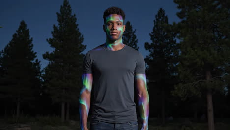 man in forest with aurora projection