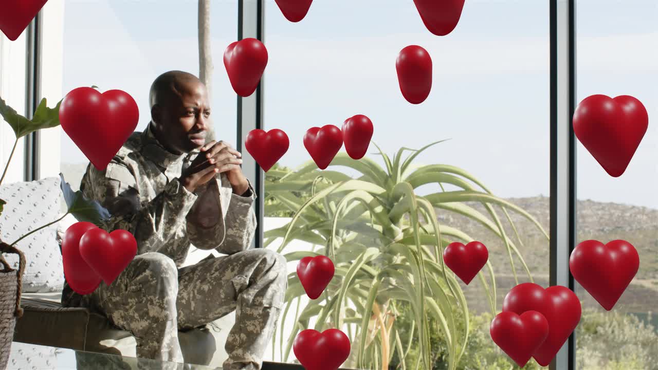 Soldier sitting clasping gazing window as animated hearts appearing, drifting, hiding for health