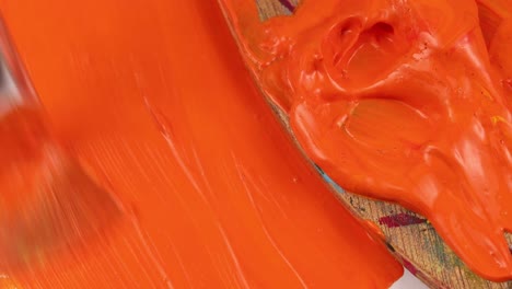 Painting-the-color-orange-on-a-piece-of-paper-filling-it