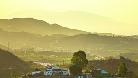 hazy sunrise over a village and highway - time lapse