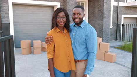 dolly shot of african american young married couple of man and woman standing at new home when moving in