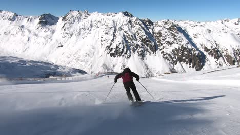 professional skier racing down a steep ski slope in rythmic short turns
