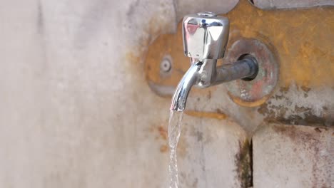 close-up of a faucet with water running