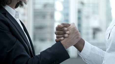 closeup shot of two women shaking hands