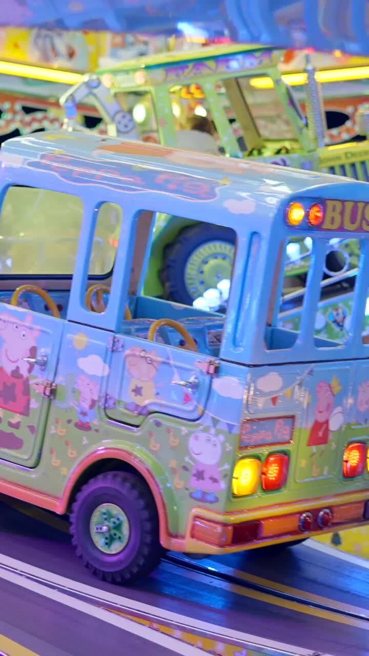 Children riding various spinning attractions at an indoor amusement park