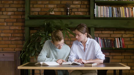 Teacher-and-student-reading-and-talking-about-the-Bible