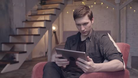 Young Man Using Tablet at Home