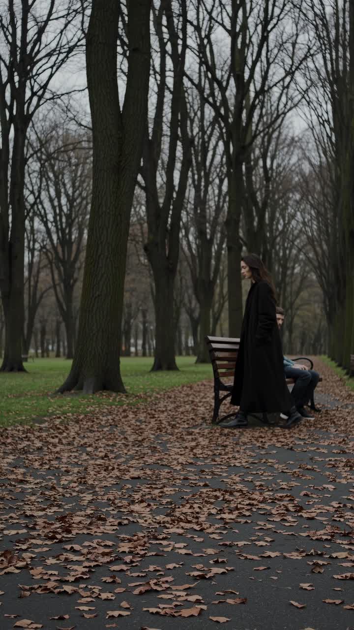 Moody park scene with a man on a bench, surrounded by bare trees and fallen leaves