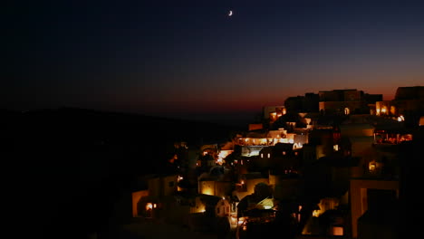 a wide shot of a village on the cliffs of santorni in the greek islands at night 2