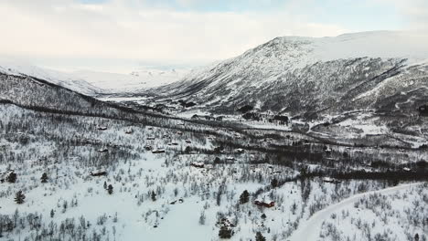 Cabins-At-Snowy-Mountain-During-Winter-In-Norway