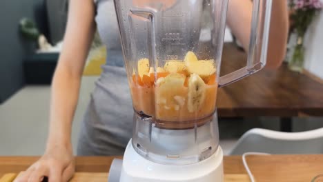 making a carrot, apple, and banana smoothie