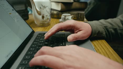 busy fingers typing on laptop keyboard in home office medium push.shot