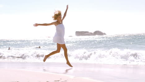 a woman is jumping with her white clothes