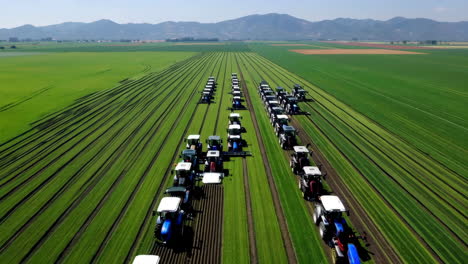 large scale farming operation with numerous tractors in green fields
