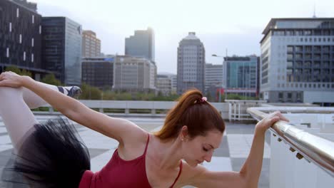 Ballet-dancer-stretching-on-pavement-4k-