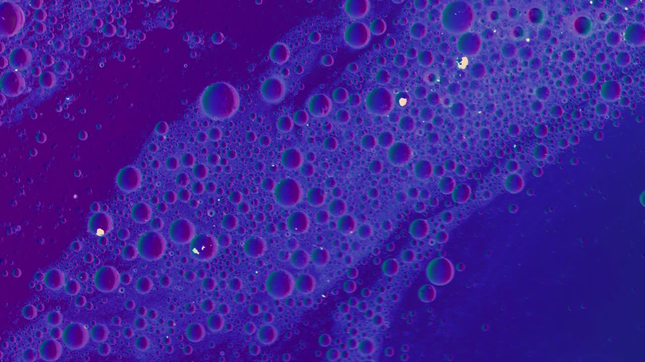 purple Greasy liquid flows over a surface with bubbles and dirt