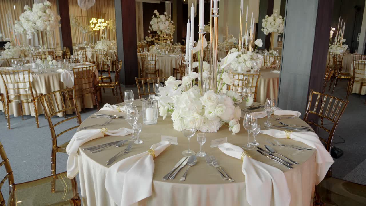 Elegant Wedding Reception Table Setting with White Flowers and Gold Accents