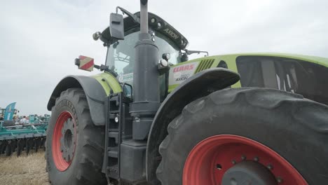 demonstration of agricultural machinery at an exhibition. tractors operate in the field, showcasing their capabilities and performance in action