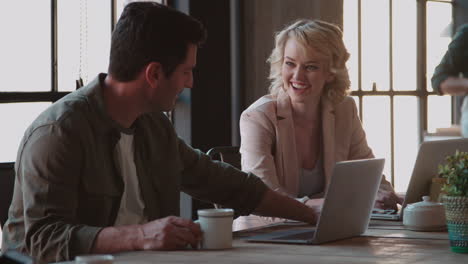 customers in coffee shop using laptops shot on r3d