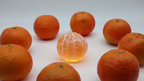 fresh mandarin oranges fruit on rotating display isolated on white background