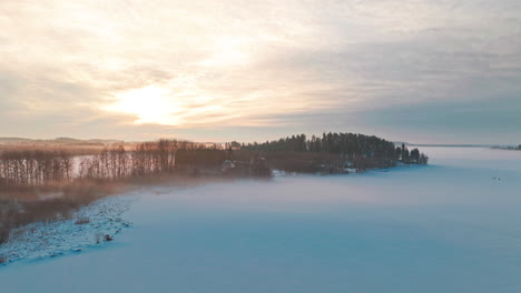 Orbiting-a-backlit-peninsula-or-cape-on-a-frozen-lake-or-sea-ice-engulfed-in-fog