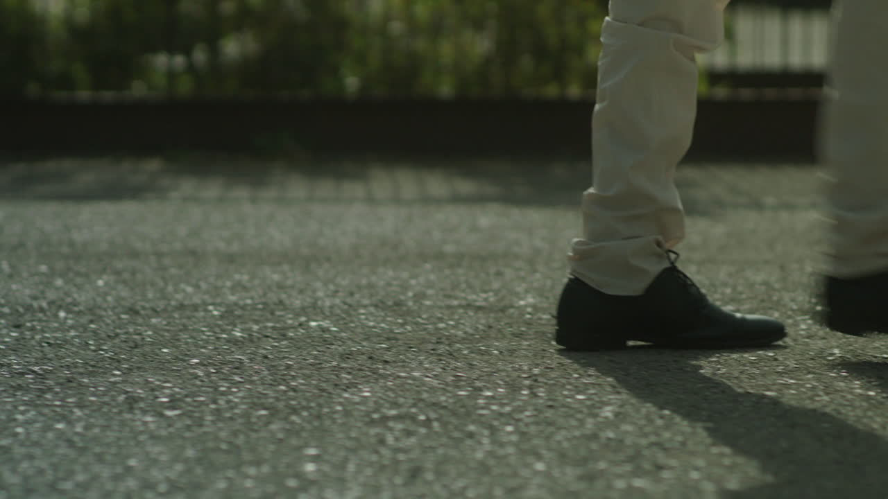 Person walking on a paved ground