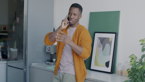 hombre hablando por teléfono en la cocina
