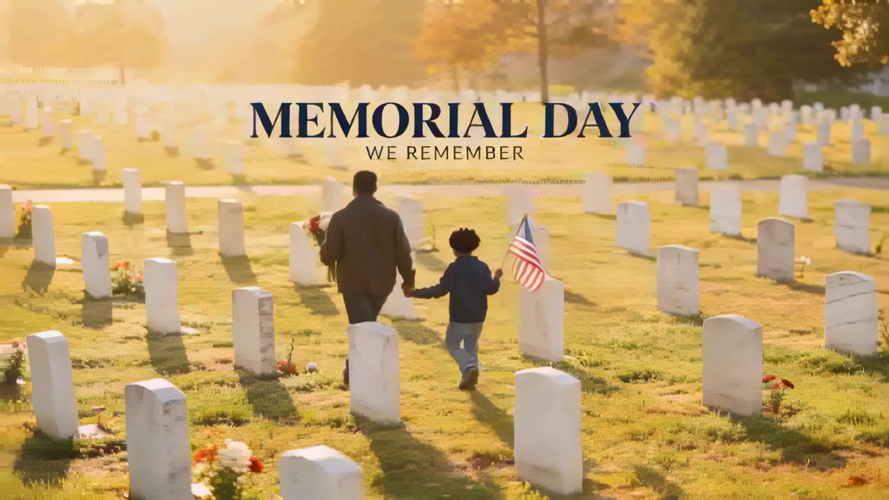 Walking dad and son holding hands at cemetery in coats carrying bouquet flag honoring MEMORIAL DAY