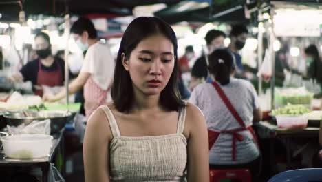 sad woman in a night market