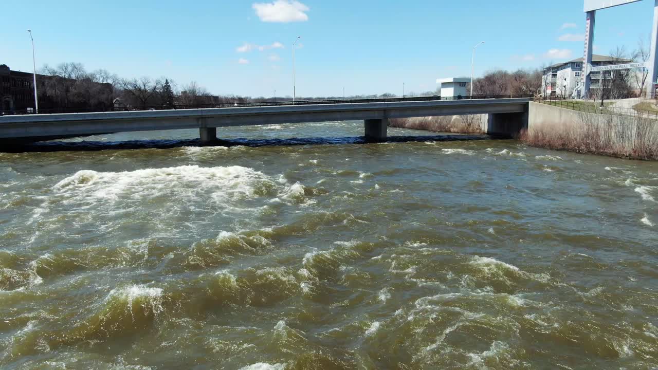 Flight over raging Fox River going underneath a bridge in Kaukauna, Wisconsin