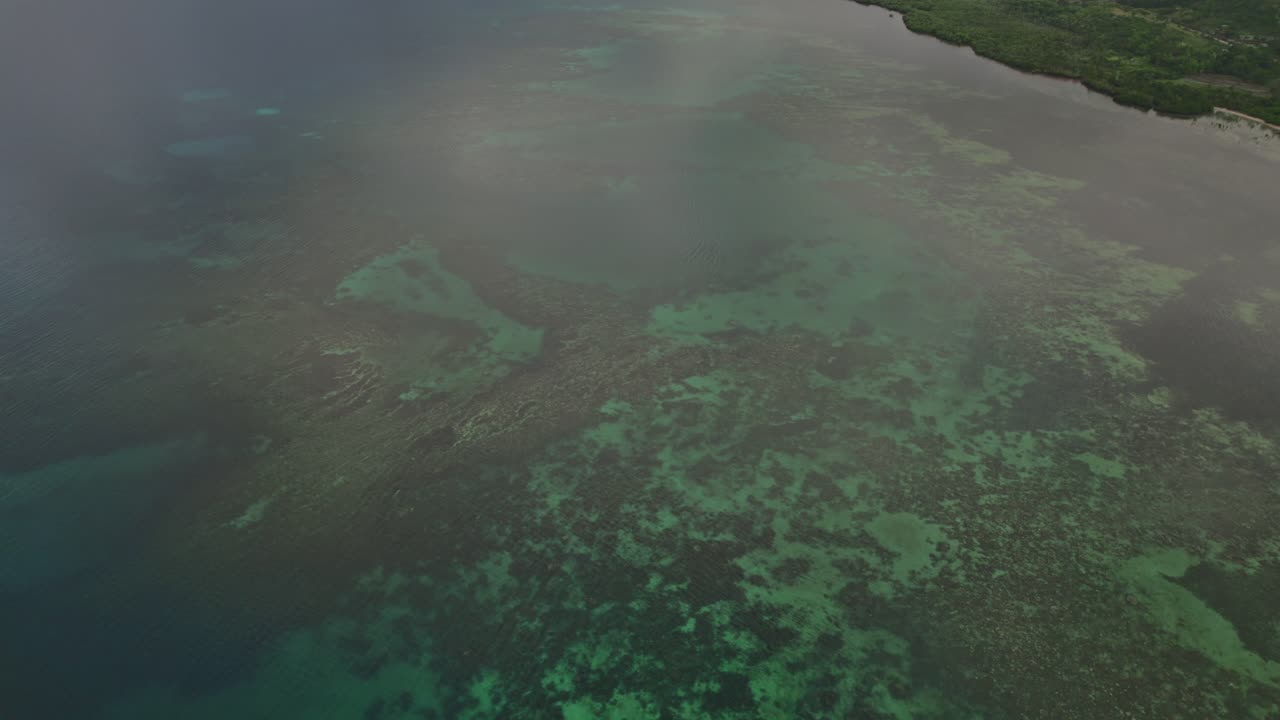 Forward aerial movement above the shallow water with marine coral reef, Southeast Asia, Philippines