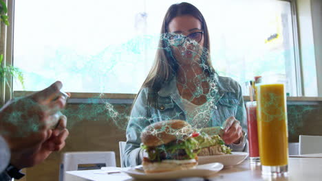 woman sampling burger and avocado toast in café, displaying animated menu icons for social media