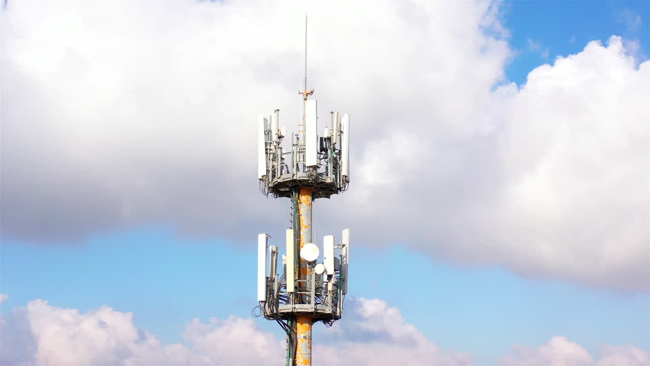 Aerial footage Close to cellular Antenna with blue sky and Clouds