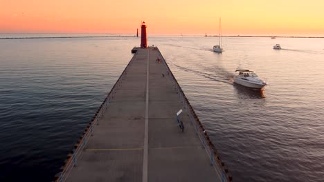 a pier jutting out into lake michigan during a romantic sunset with beautiful colors