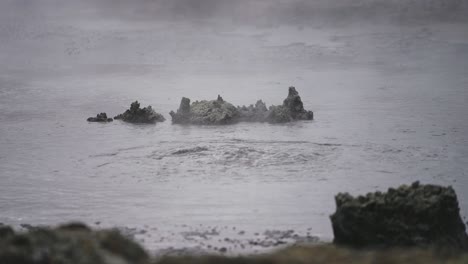 Boiling-hot-geothermal-volcanic-mud-pool,-closeup-shot-steamy-lake-bubbling-mud-and-steam