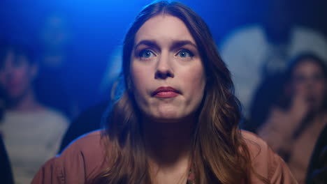 focused woman watching movie in cinema