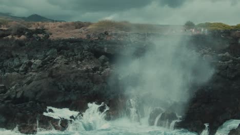 4k aerial water geyser on volcanic coast