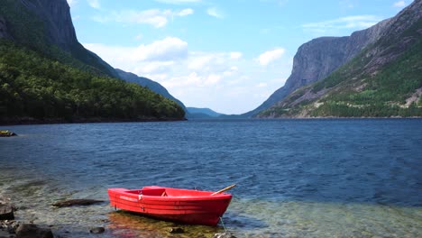 Barco-Turístico-En-La-Orilla-Del-Fiordo-En-Noruega-Con-Montañas-En-El-Fondo