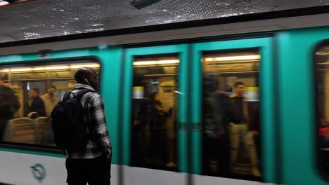 person observes a moving train at a station