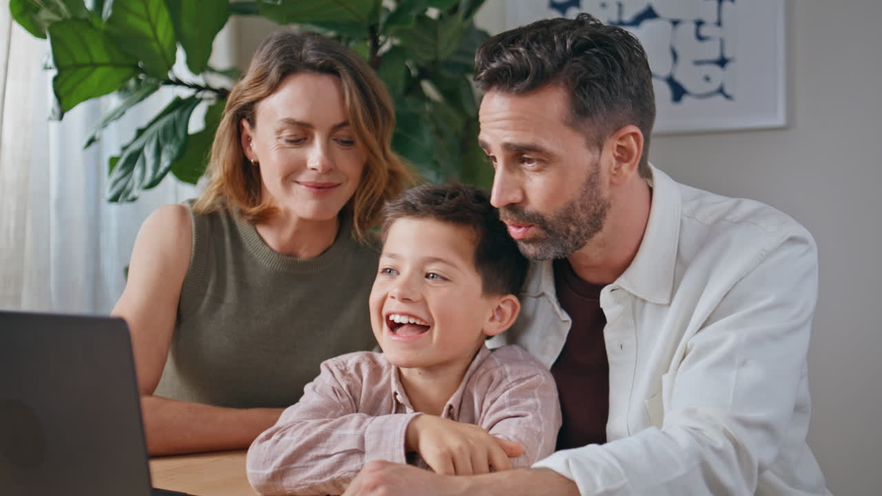 Joyful relatives virtual conference flat closeup. Parents child looking laptop