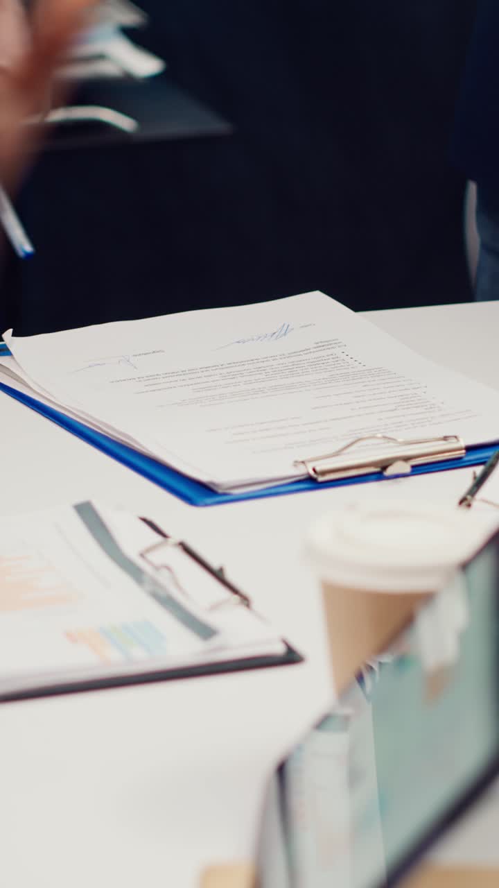 Close-up of Businesspeople Signing Contract Document in Office