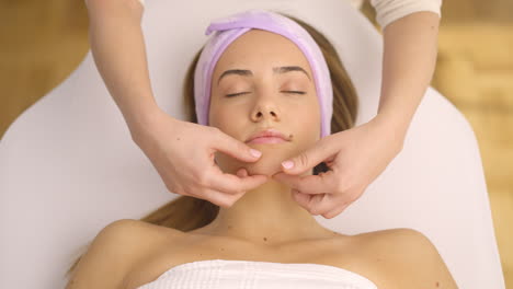 woman receiving facial massage